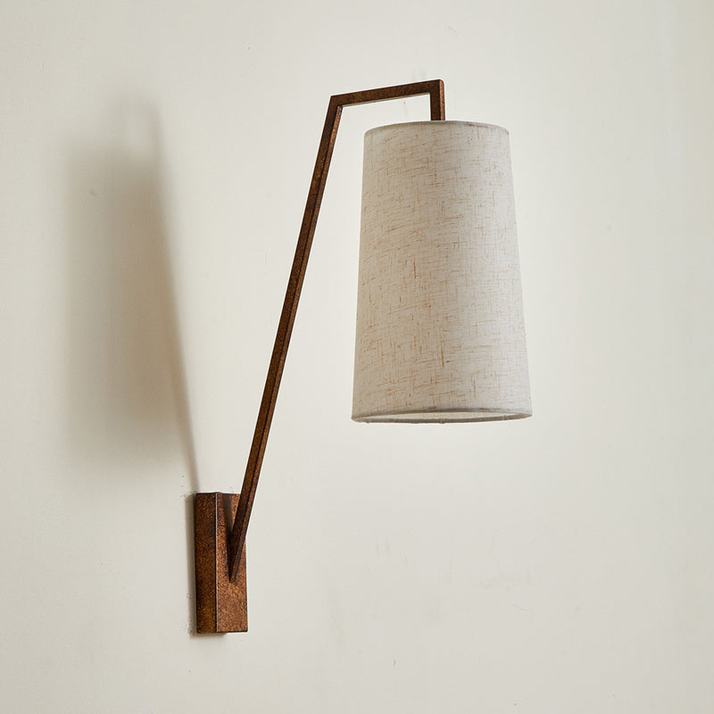 Bonny Wall Light in brass finish, showcasing its geometric lines.