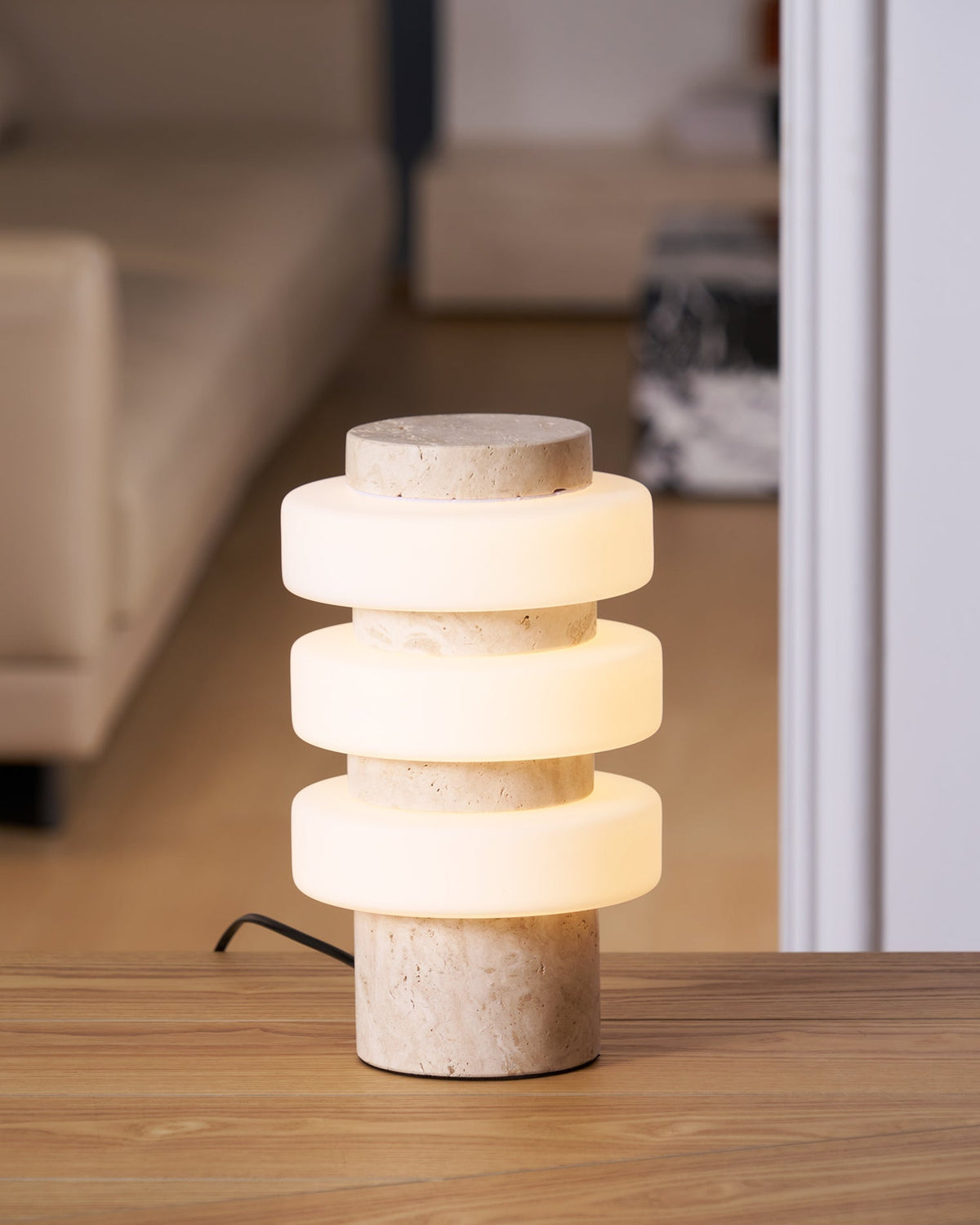 Lifestyle image of the Corba Table Lamp in a contemporary bedroom.