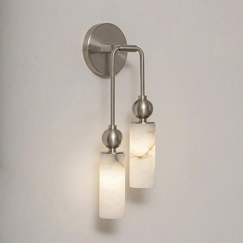 The Metro Alabaster Wall Lamp with a black finish against a light wall.