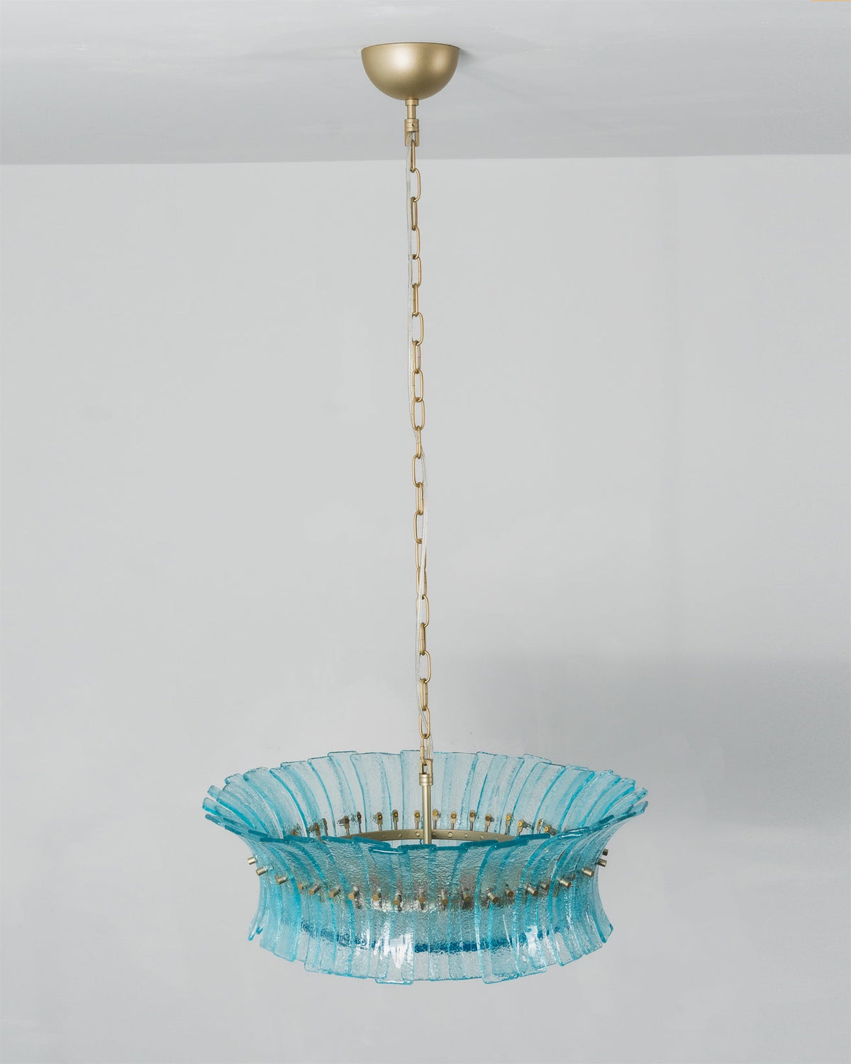 Close-up on the translucent aquamarine pigment of the glass.