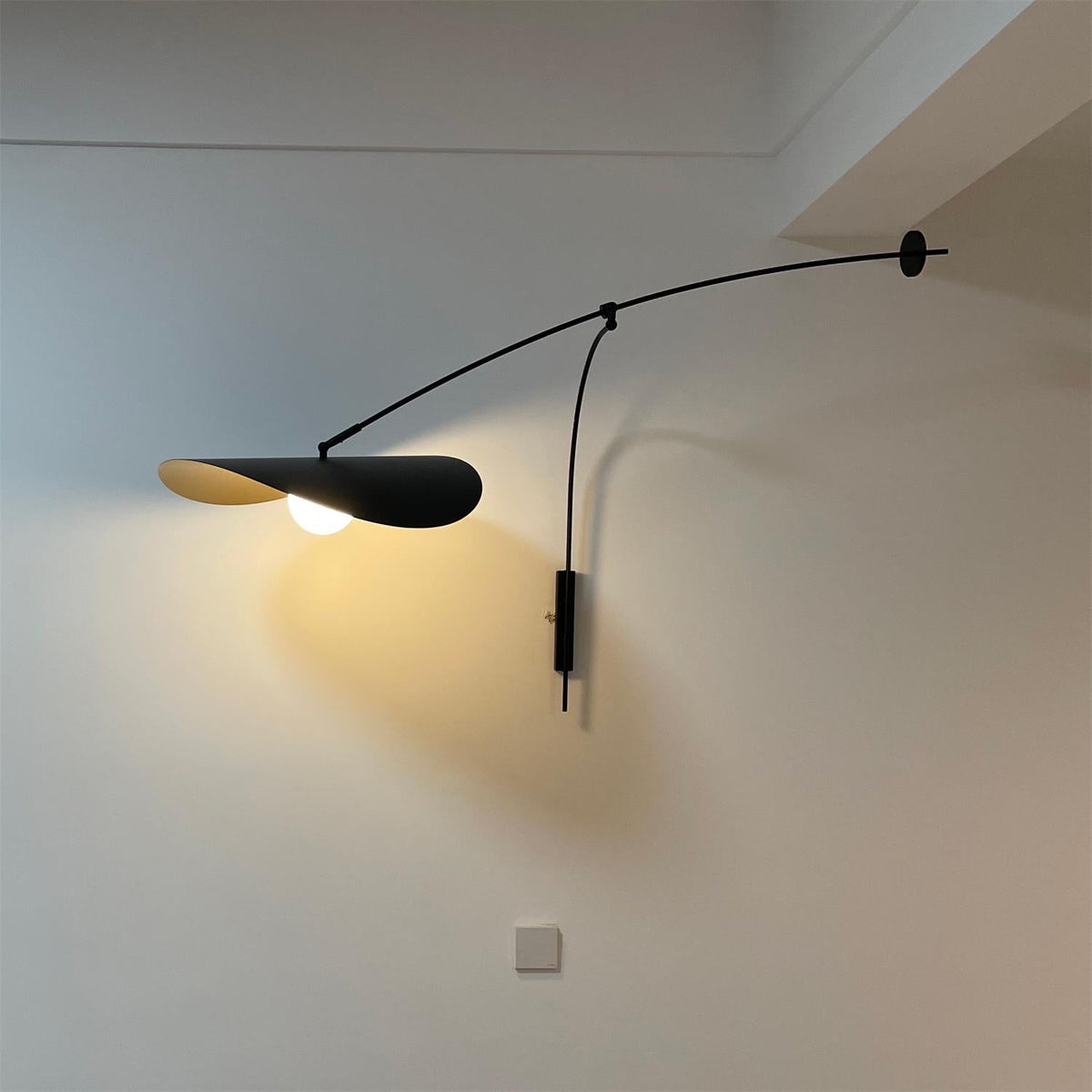 The sculptural silhouette of the Myrna Wall Lamp.
