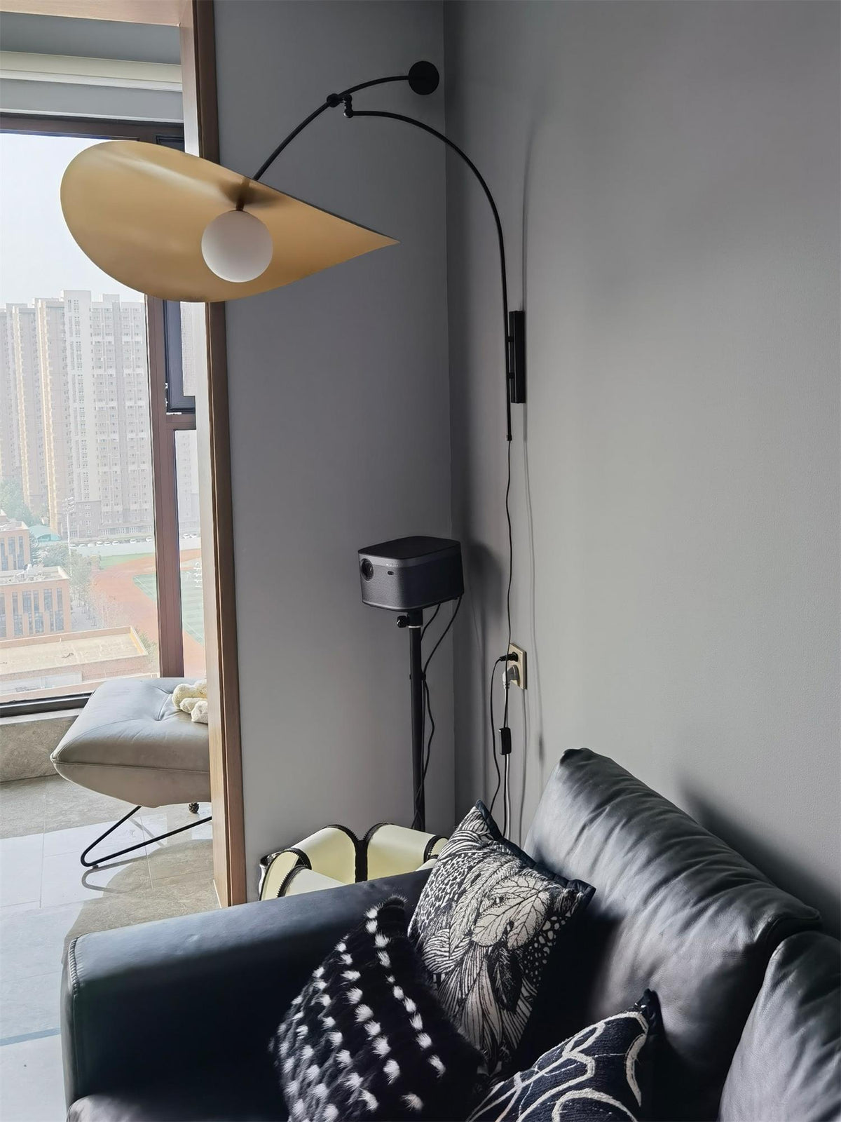 The small size Myrna Wall Lamp in a minimalist bedroom setting.