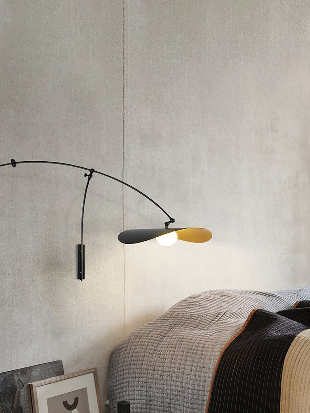 Detail of the black metal arms and joints of the Myrna Wall Lamp.