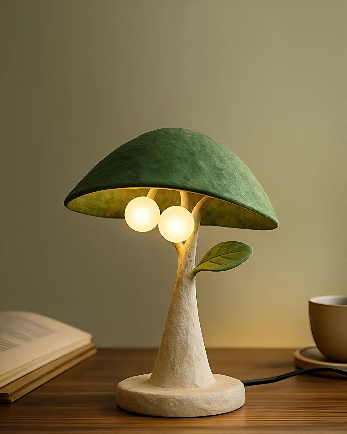 Side view of the Soloma Table Lamp showing the sculpted leaf detail on the resin trunk.