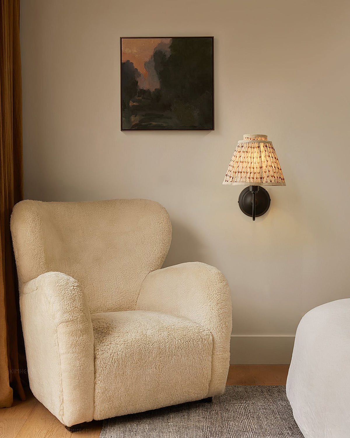 The Elbow Wall Light providing warm, ambient light in a reading nook.