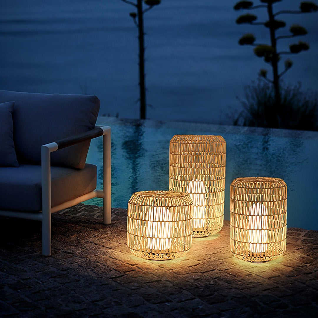 The outdoor lamp shown illuminating a patio setting at dusk.