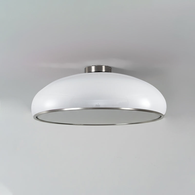 Lifestyle view of the orange Aicia Ceiling Light over a dining table.