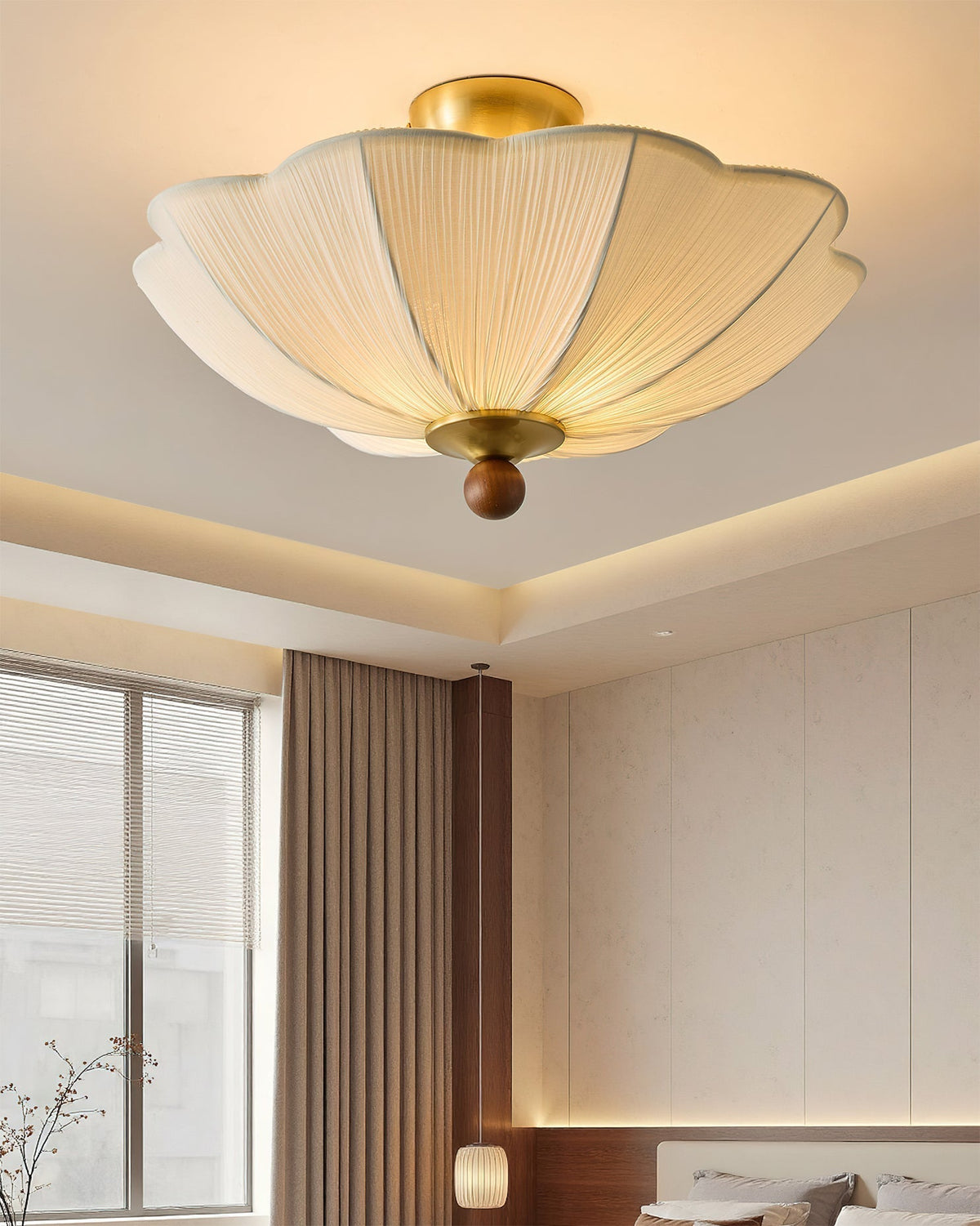 Close-up view of the pleated beige fabric shade and walnut accent.