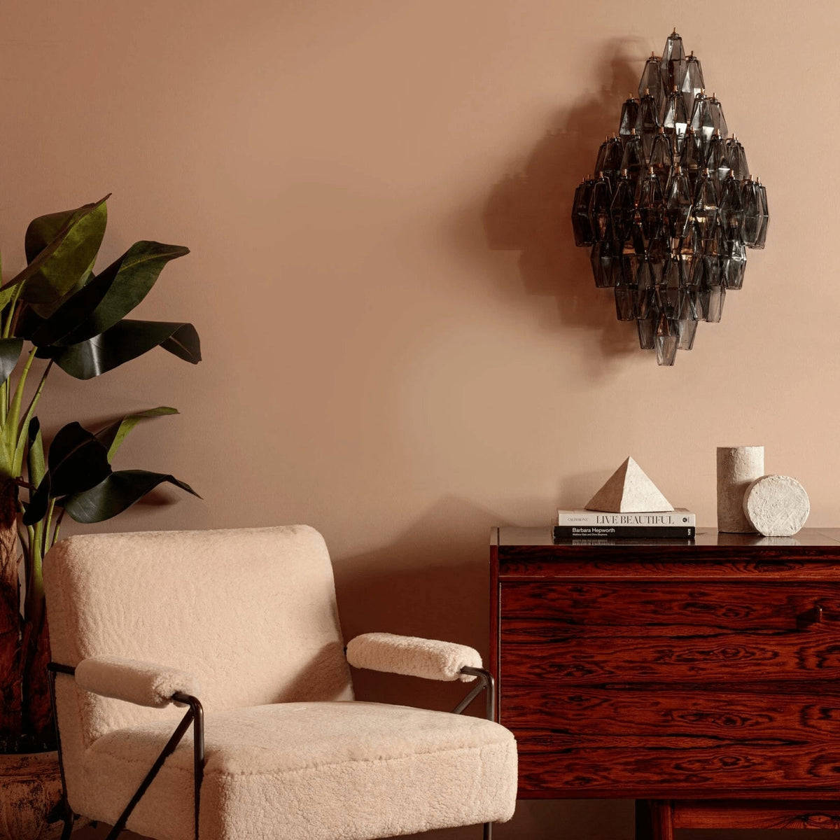 Angled view of the Biscayne Polyhedral Glass Sconce showcasing its multi-tiered glass prisms.
