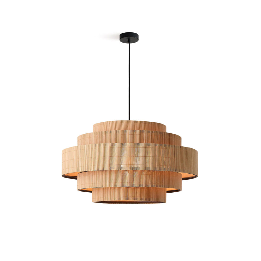 The Calista bamboo pendant light hanging in a modern living room, casting a warm glow.