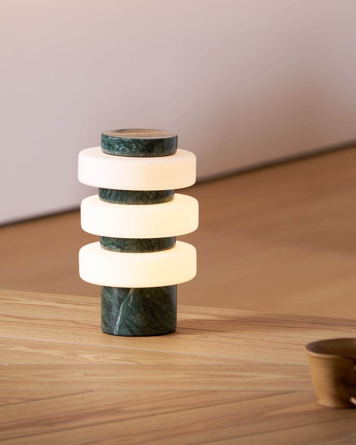 Corba Table Lamp illuminating a modern living room.