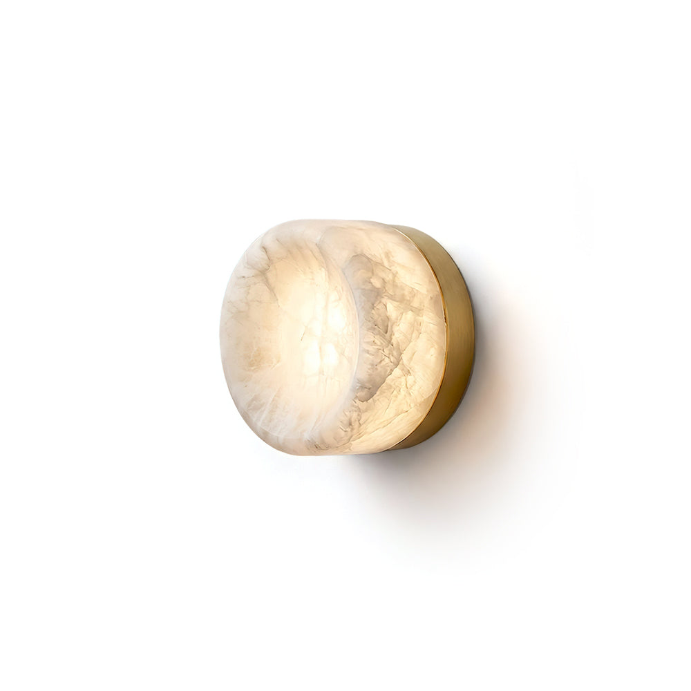 Concave Disc Alabaster Wall Sconce in brass finish against a neutral wall.