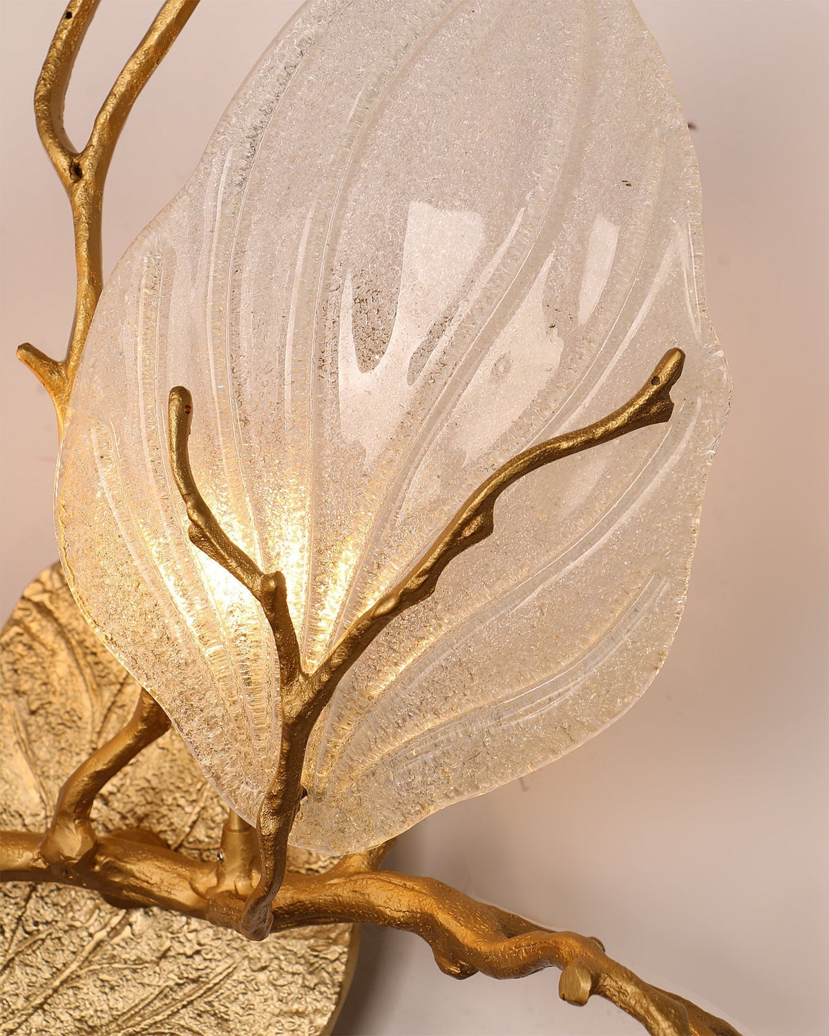 The textured finish of the hand-cast brass branch.