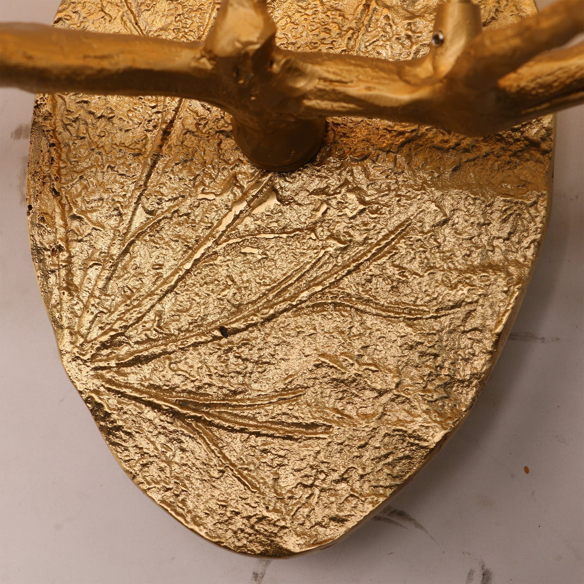 Angled view of the Magnolia Leaf sconce, showing its sculptural form.