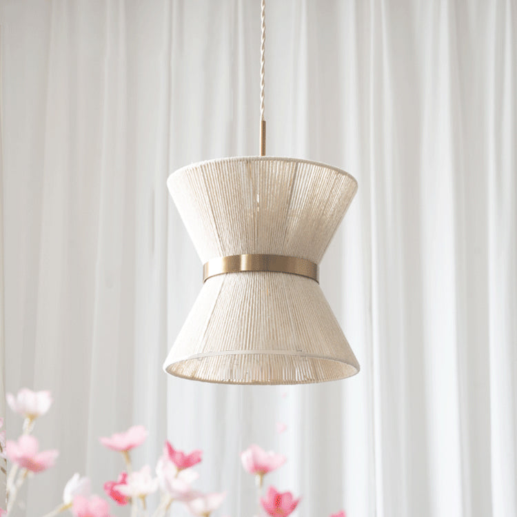 Lifestyle image showcasing the warm glow of the Elara Woven Pendant Light when illuminated.