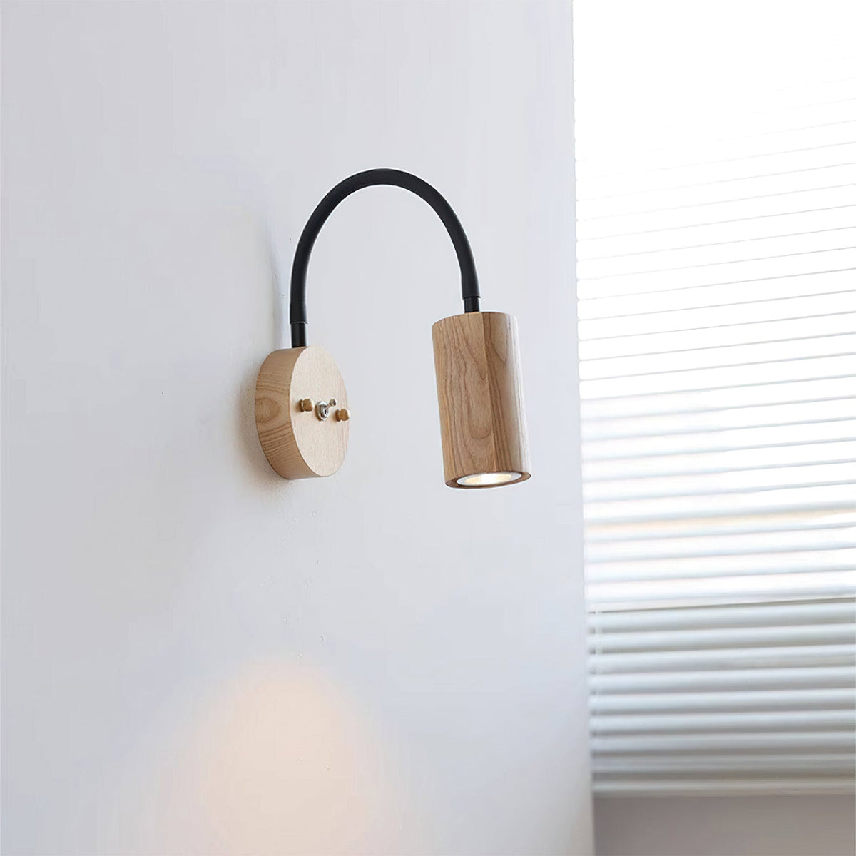 Side view of the Micro Wall Lamp showing the curved black arm.