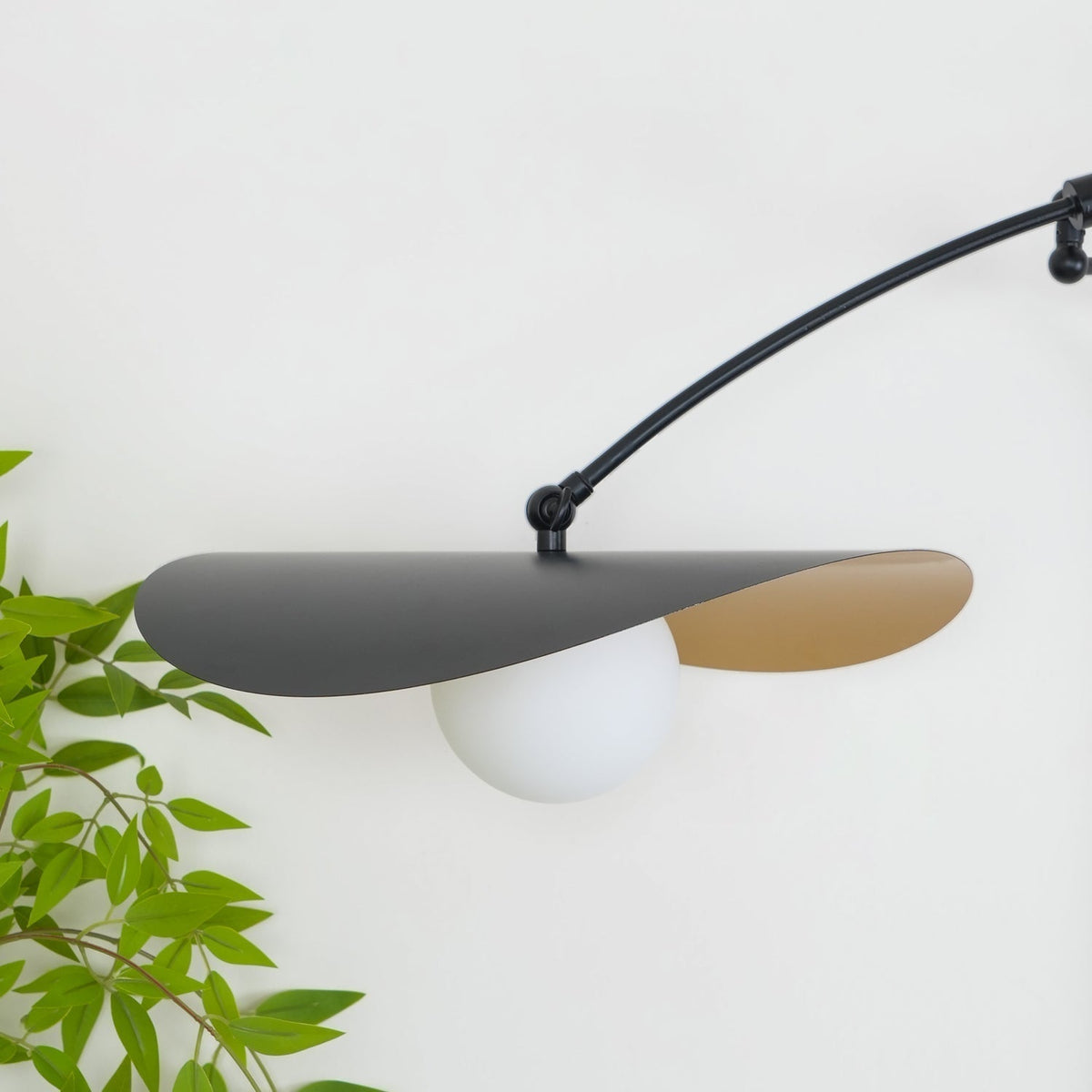 Close-up of a glass shade on the Myrna Wall Lamp.