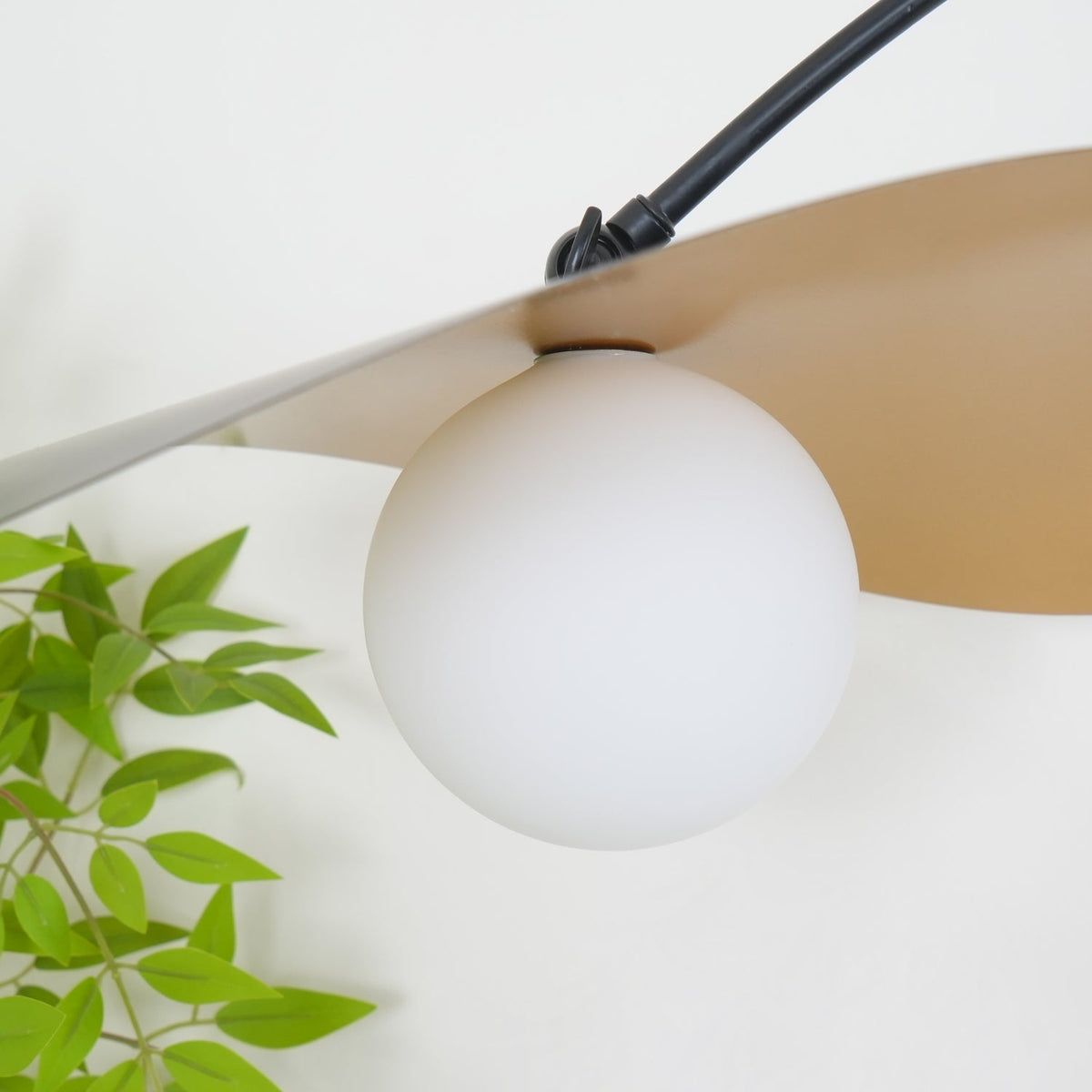 Detail of the black metal arms and joints of the Myrna Wall Lamp.