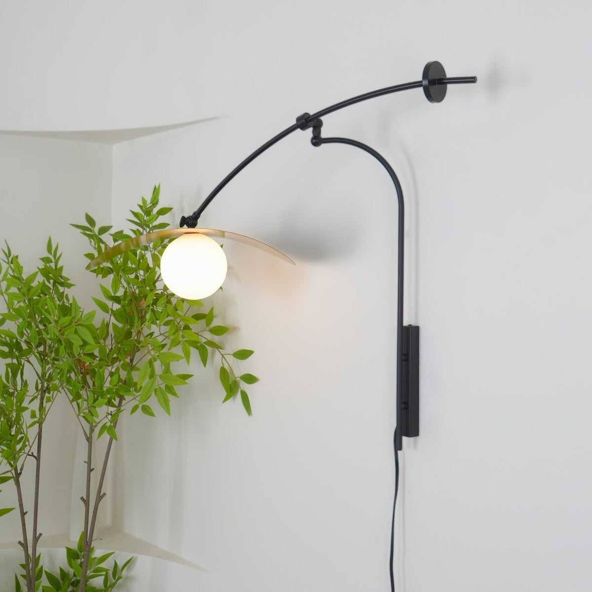 Lifestyle image featuring the Myrna Wall Lamp in a chic living room.