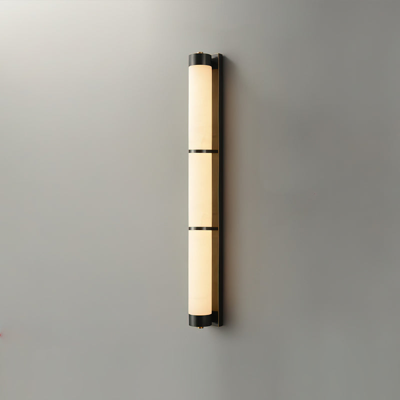 The wall light illuminating a dark, elegant space.