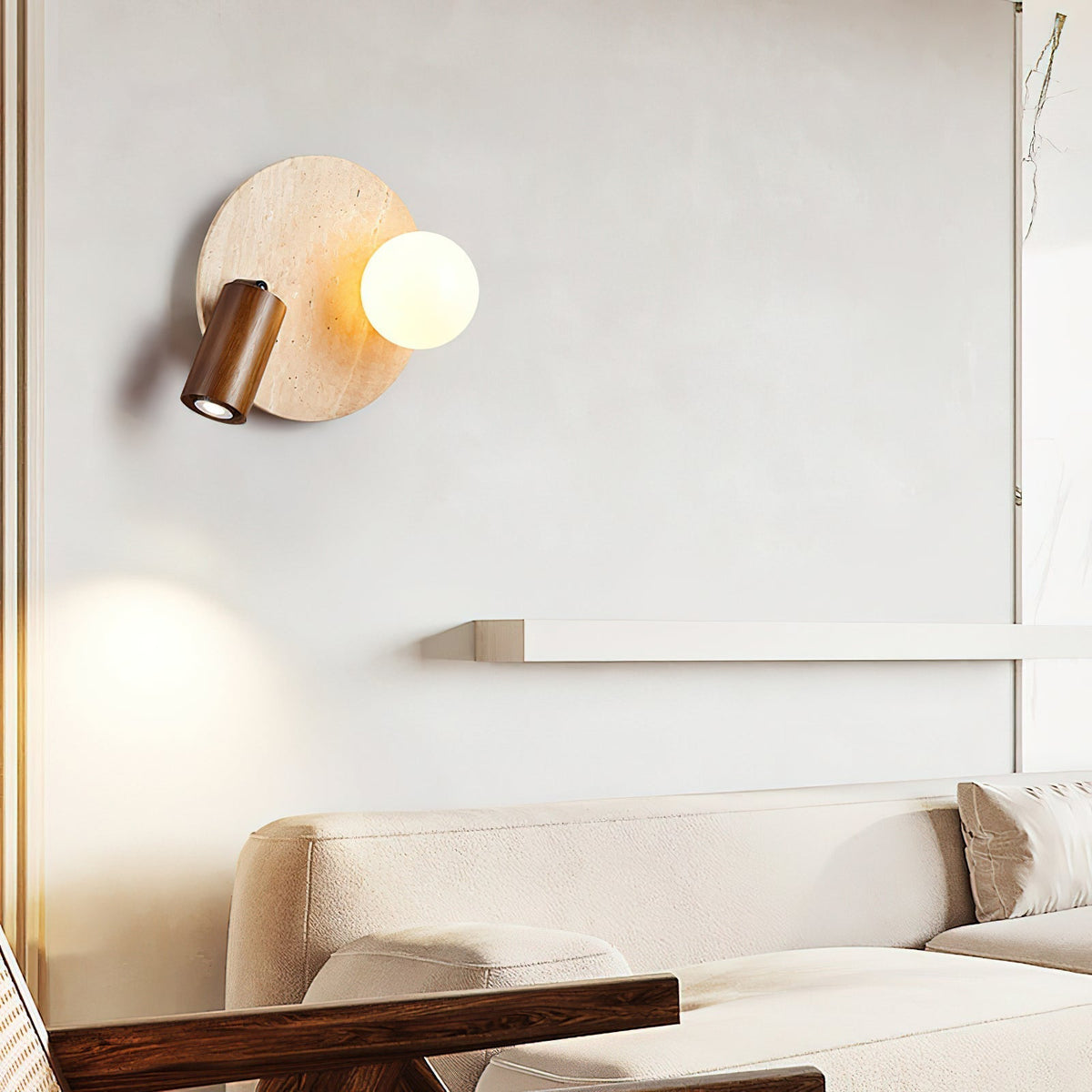 Luka Travertine Wall Lamp installed as a bedside reading light.