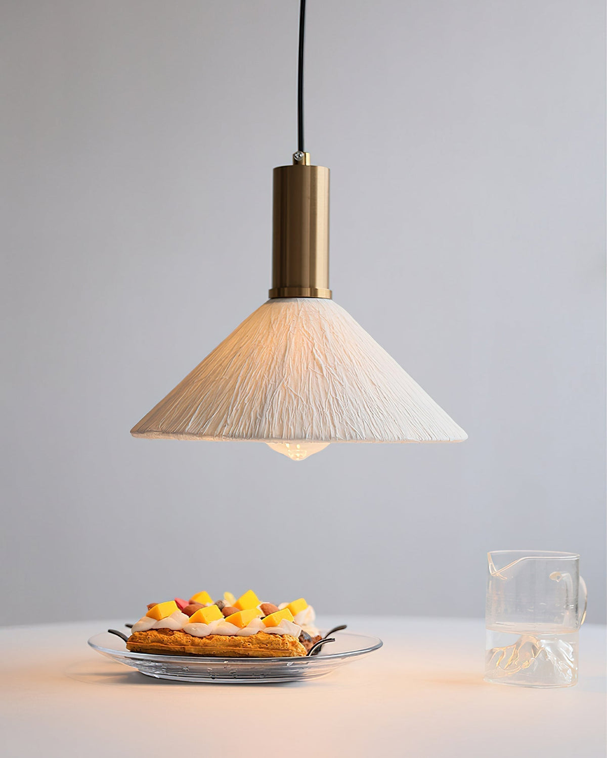 The Siya Pendant Light illuminated, casting a warm and inviting glow.