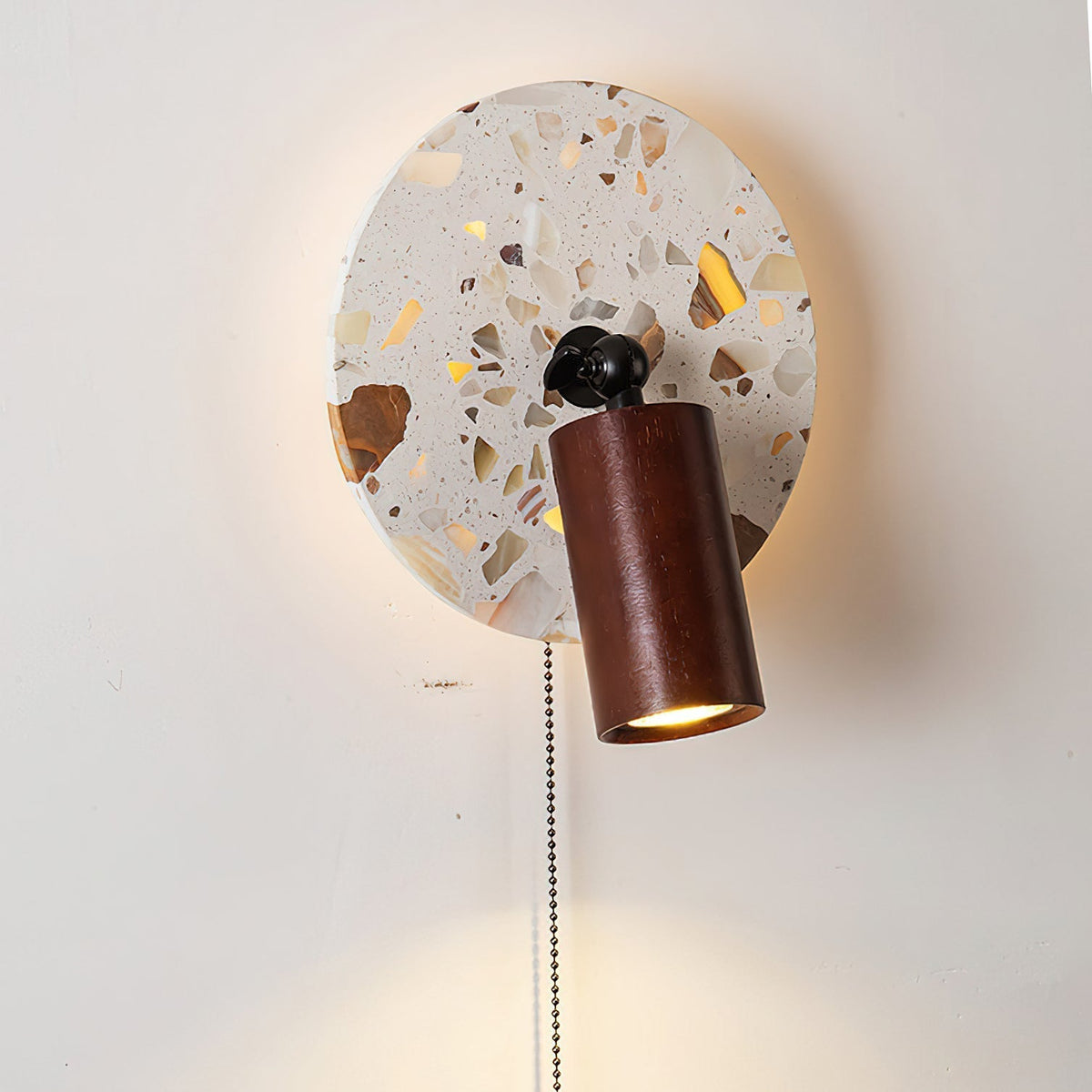 Detail shot of the amber and earth-toned fragments in the stone mosaic.