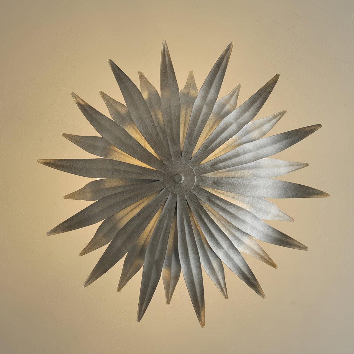 Large gold Vicenzio pendant light styled over a round dining table.
