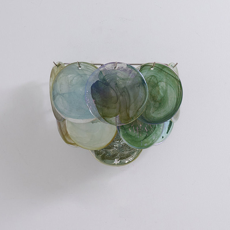 Close-up of the handcrafted swirled glass discs on the Vistosi wall lamp.