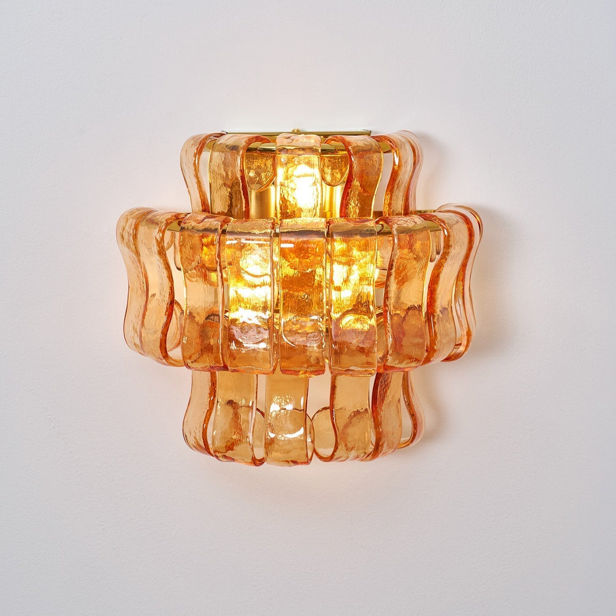 Angled shot of the clear glass Albano Wall Lamp.