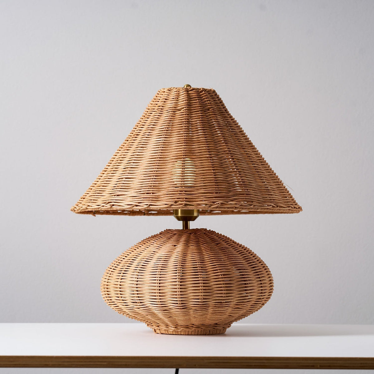 The soft, textured light pattern cast by the lamp on a nearby wall.